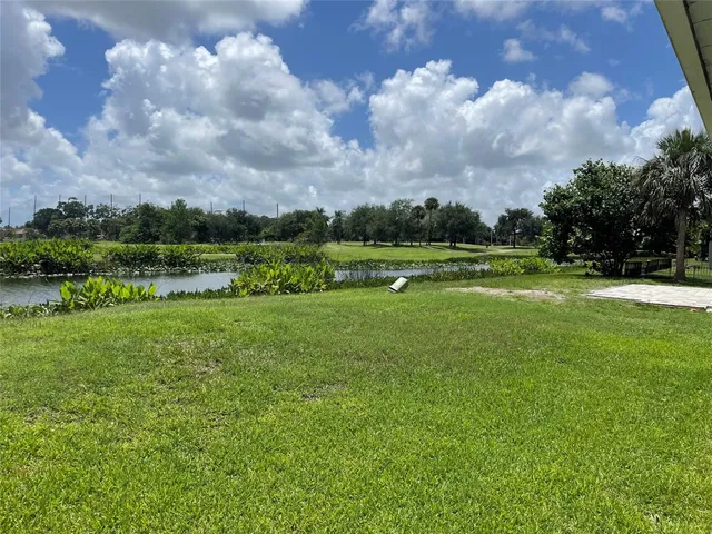 a view of outdoor space with playground and green space