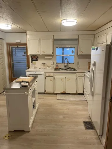 a kitchen with stainless steel appliances granite countertop a stove top oven a refrigerator a sink and dishwasher