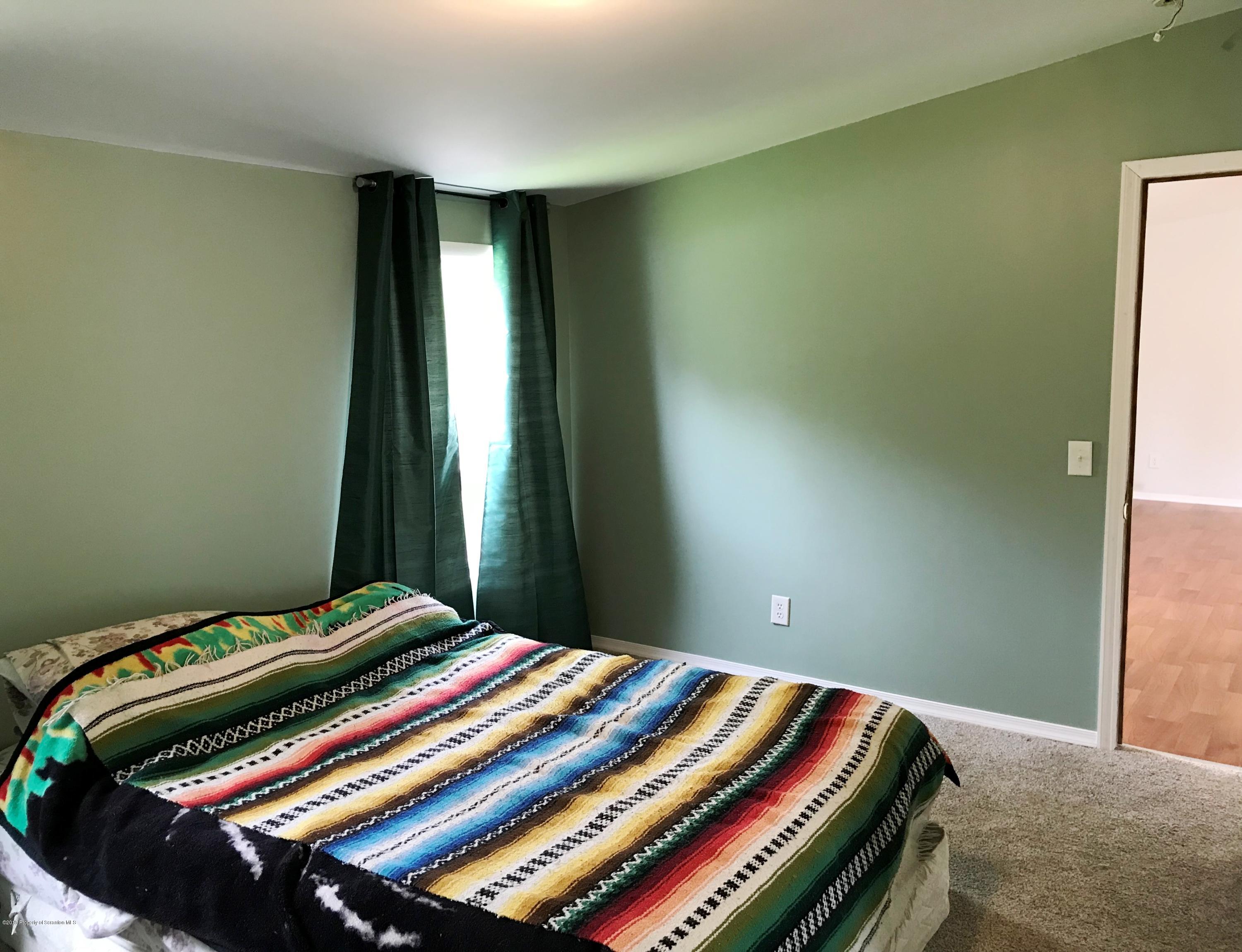 3961 Jubilee Road Moscow, PA 18444 - Photo 8 of 22 a bedroom with a bed and a window