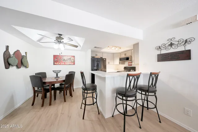 a dining room with furniture wooden floor and a rug