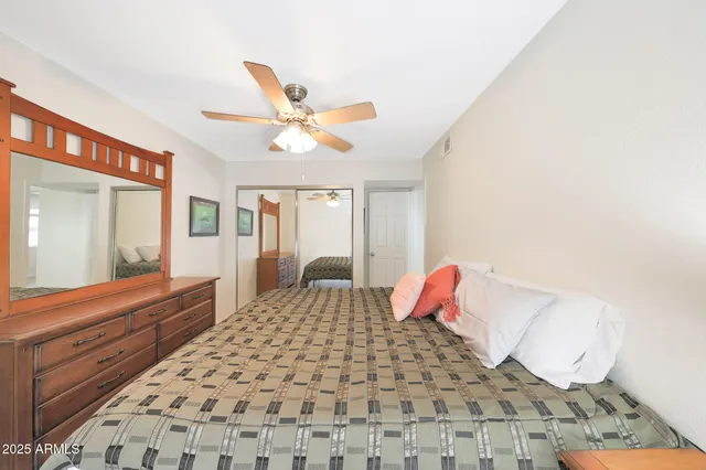 a bedroom with a bed and a large window