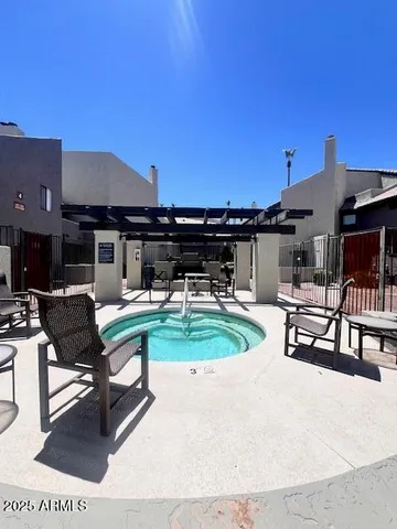 a swimming pool with outdoor seating and yard