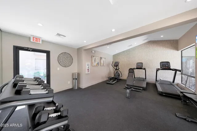 a room with gym equipment and a large window