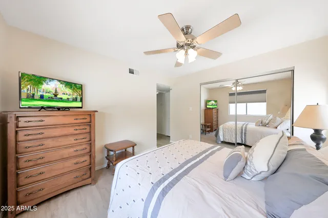 a bedroom with a bed and a flat screen tv