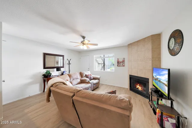 a living room with furniture a fireplace and a flat screen tv