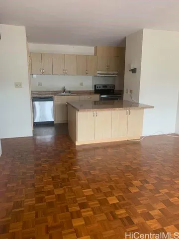 a kitchen with granite countertop a sink a stove a microwave and cabinets