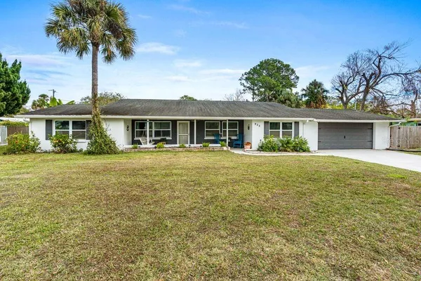a front view of a house with a garden