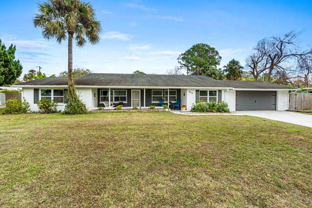 a front view of a house with a garden