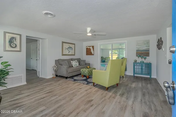 a living room with furniture and wooden floor