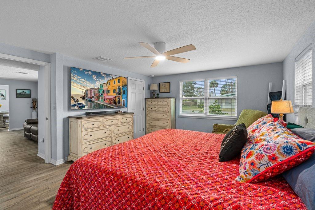 925 Flagler Avenue Edgewater, FL 32132 - Photo 19 of 35 a bedroom with a bed and a flat screen tv