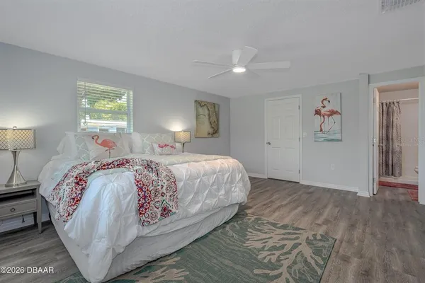 a bedroom with a large bed and a lamp