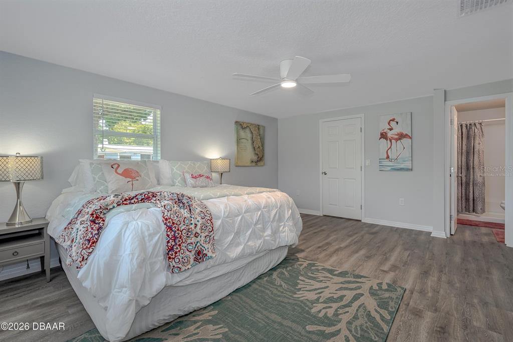 925 Flagler Avenue Edgewater, FL 32132 - Photo 24 of 35 a bedroom with a large bed and a lamp