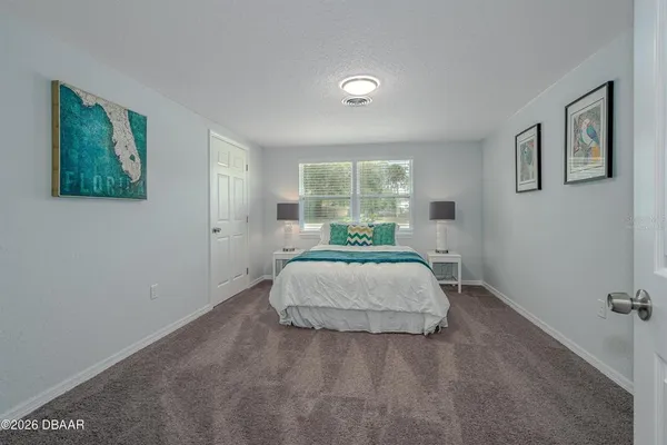 a bedroom with a bed and window