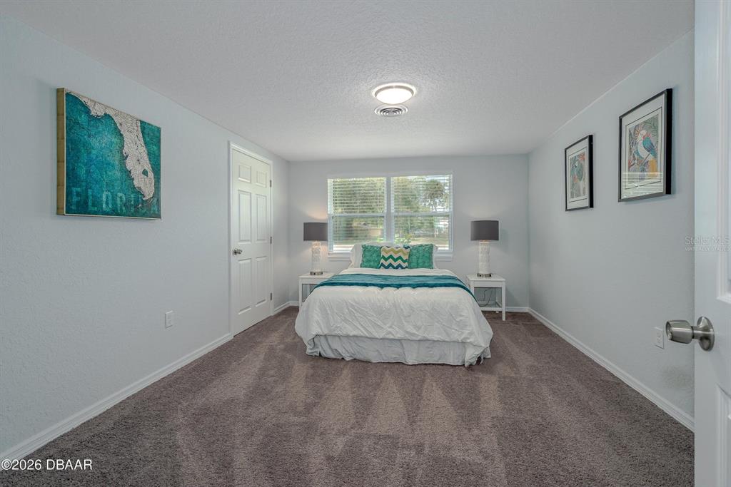 925 Flagler Avenue Edgewater, FL 32132 - Photo 25 of 35 a bedroom with a bed and window