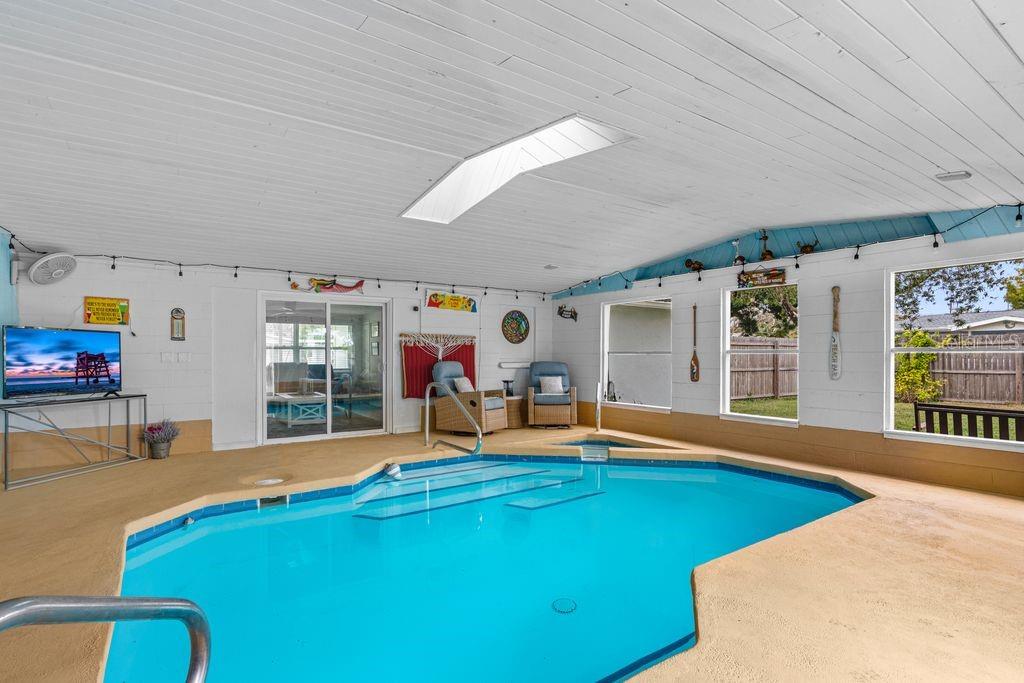 925 Flagler Avenue Edgewater, FL 32132 - Photo 27 of 35 a living room with furniture pool table and a fireplace