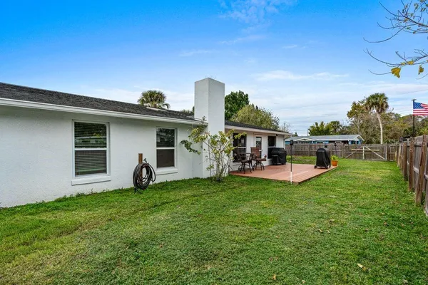 a view of a house with backyard porch and furniture