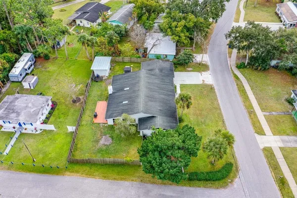 an aerial view of a house with a garden and swimming pool