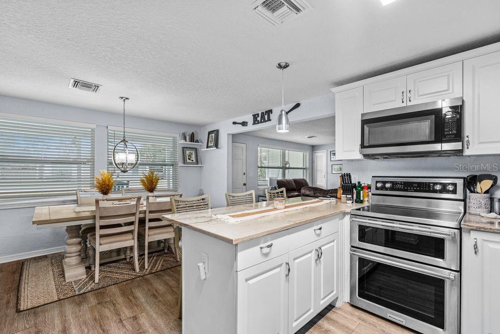 925 Flagler Avenue Edgewater, FL 32132 - Photo 6 of 35 a kitchen with a stove and a microwave