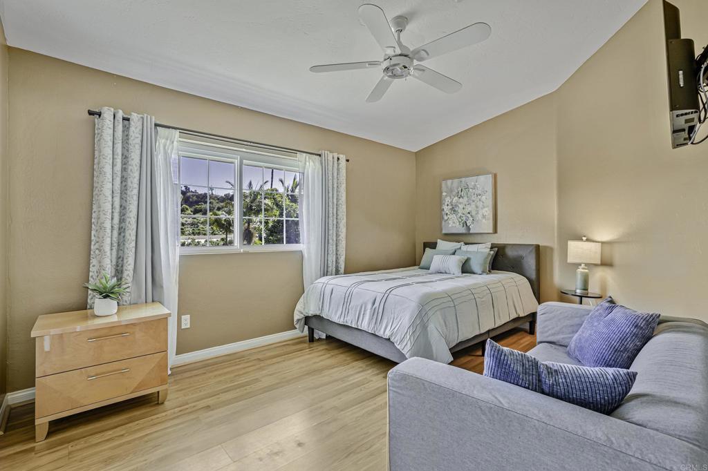 1460 Orpheus Avenue Encinitas, CA 92024 - Photo 11 of 24 a spacious bedroom with a bed and a window