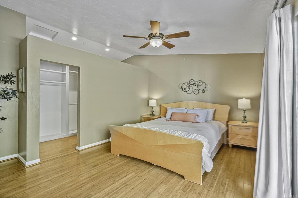 1460 Orpheus Avenue Encinitas, CA 92024 - Photo 17 of 24 a bedroom with a bed and wooden floor