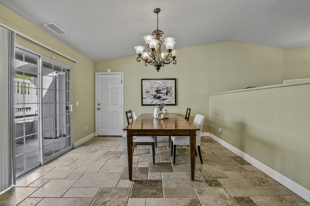 1460 Orpheus Avenue Encinitas, CA 92024 - Photo 7 of 24 a dining room with chandelier and glass door