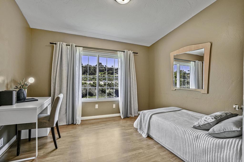 1460 Orpheus Avenue Encinitas, CA 92024 - Photo 8 of 24 a bedroom with a bed and a table