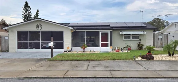 a front view of a house with a yard and glass windows