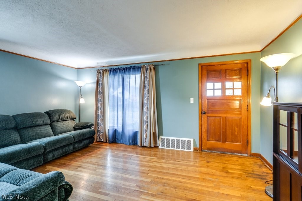 30000 Elgin Road Wickliffe, OH 44092 - Photo 11 of 30 Spacious living area featuring wood-finish flooring, a paneled entry door with glass inserts, and a large window