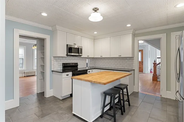 a kitchen with stainless steel appliances granite countertop sink refrigerator and microwave
