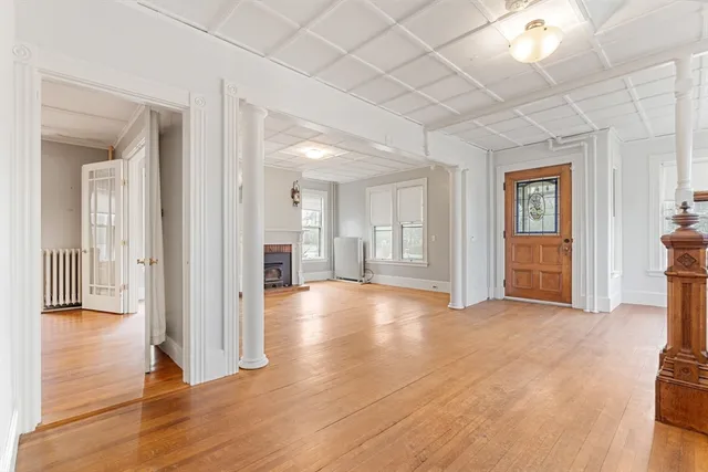 a view of a livingroom with wooden floor and windows