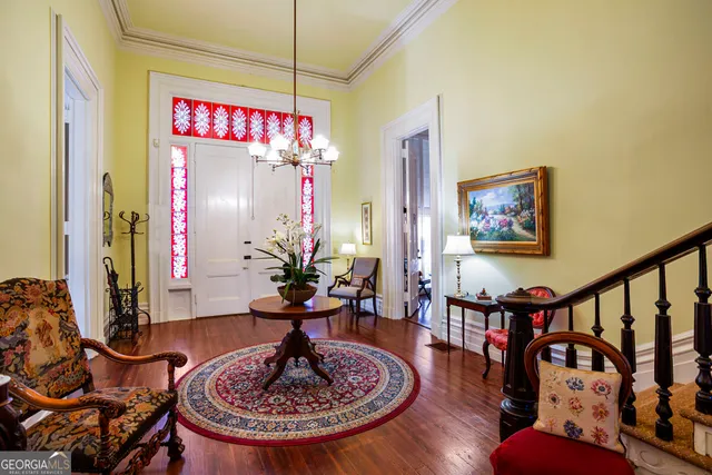 a living room with furniture a fireplace and a chandelier