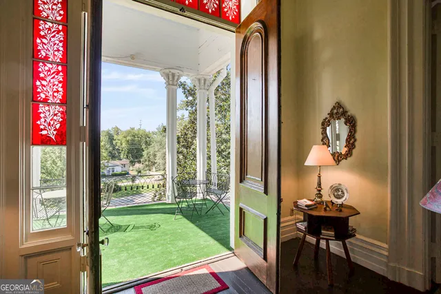 a view of a house with backyard and sitting area