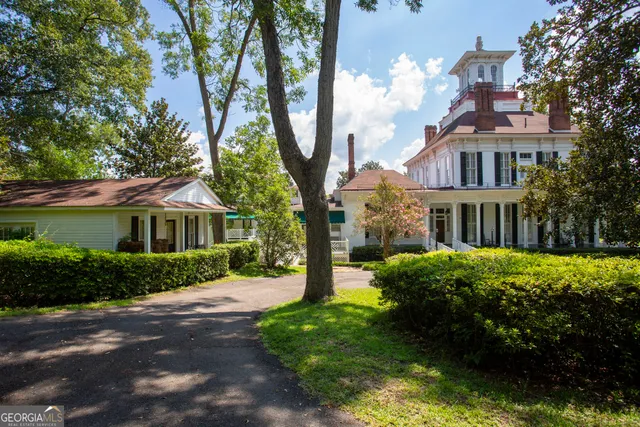 a front view of a house with garden