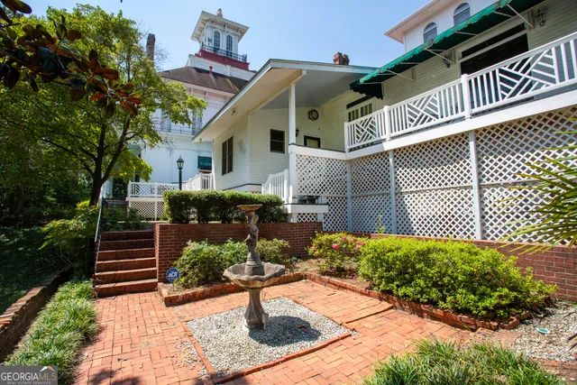 a bedroom with two beds and painting on the wall