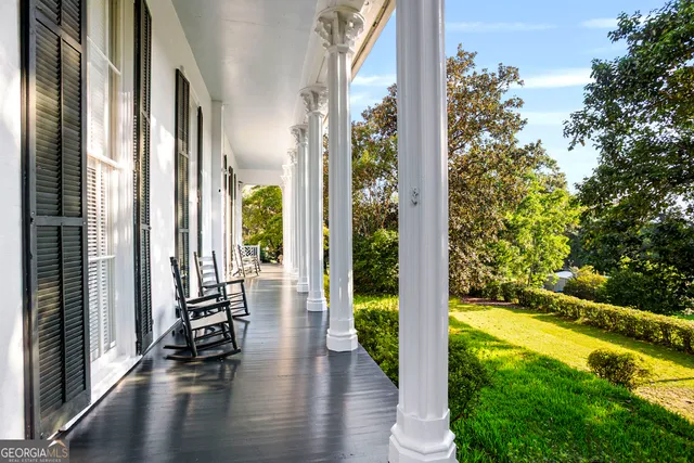 a living room with furniture and a mirror
