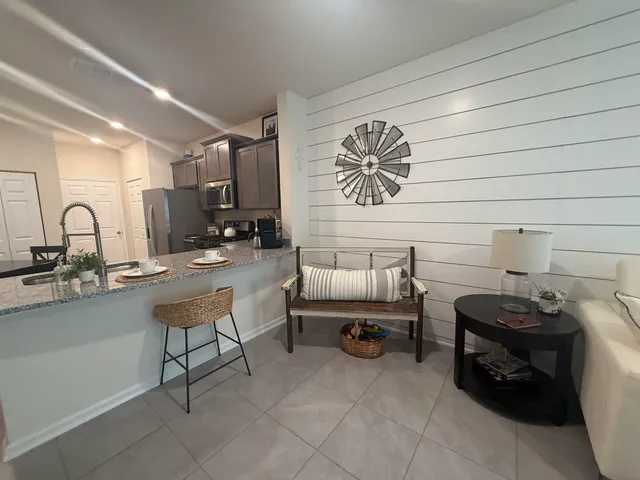 a kitchen with stainless steel appliances granite countertop a sink refrigerator and microwave