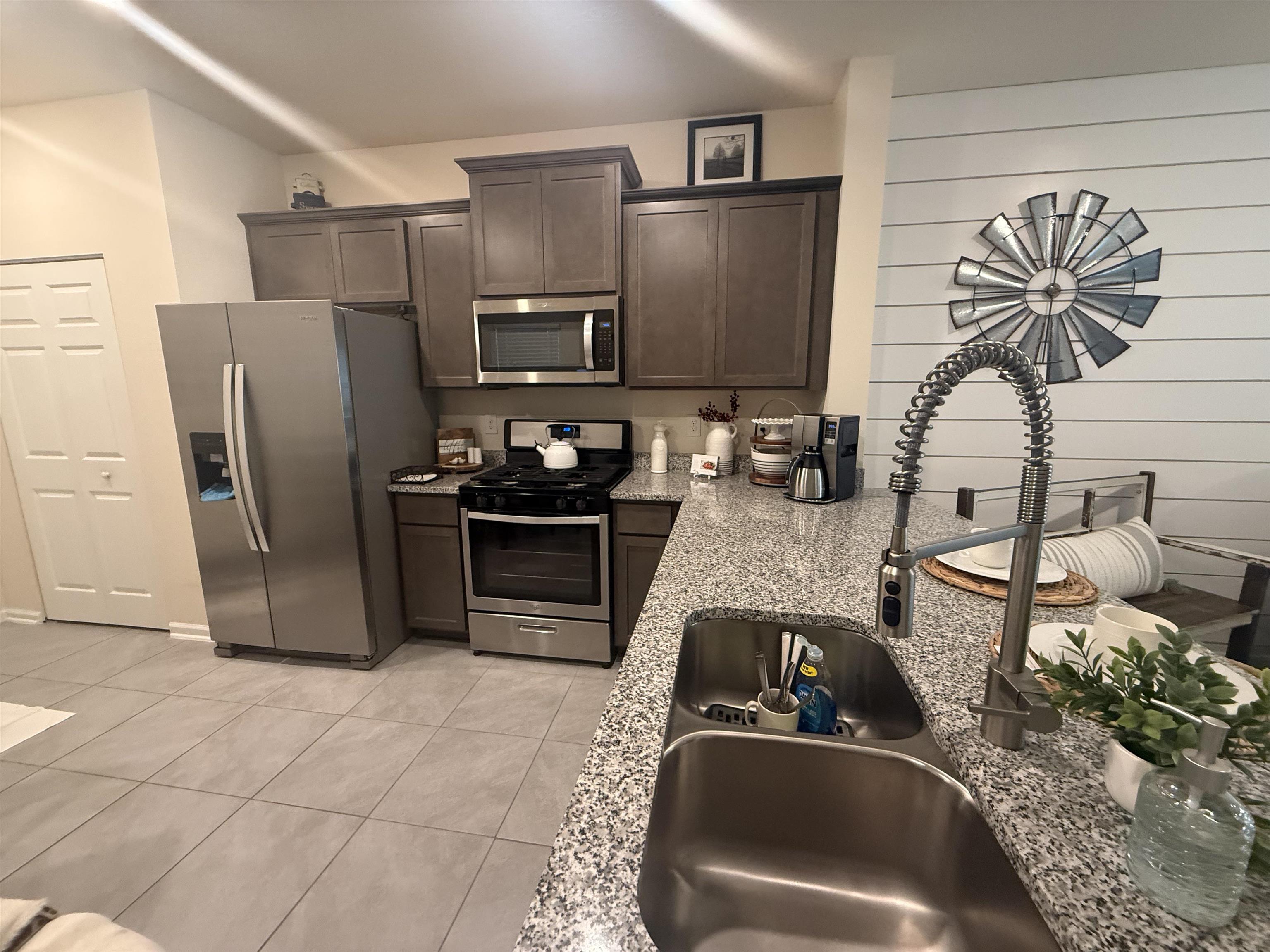 64 Coastline Way St. Augustine, FL 32092 - Photo 13 of 43 a kitchen with stainless steel appliances granite countertop a sink refrigerator and microwave