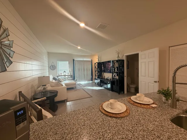 a view of a dining room with furniture and window
