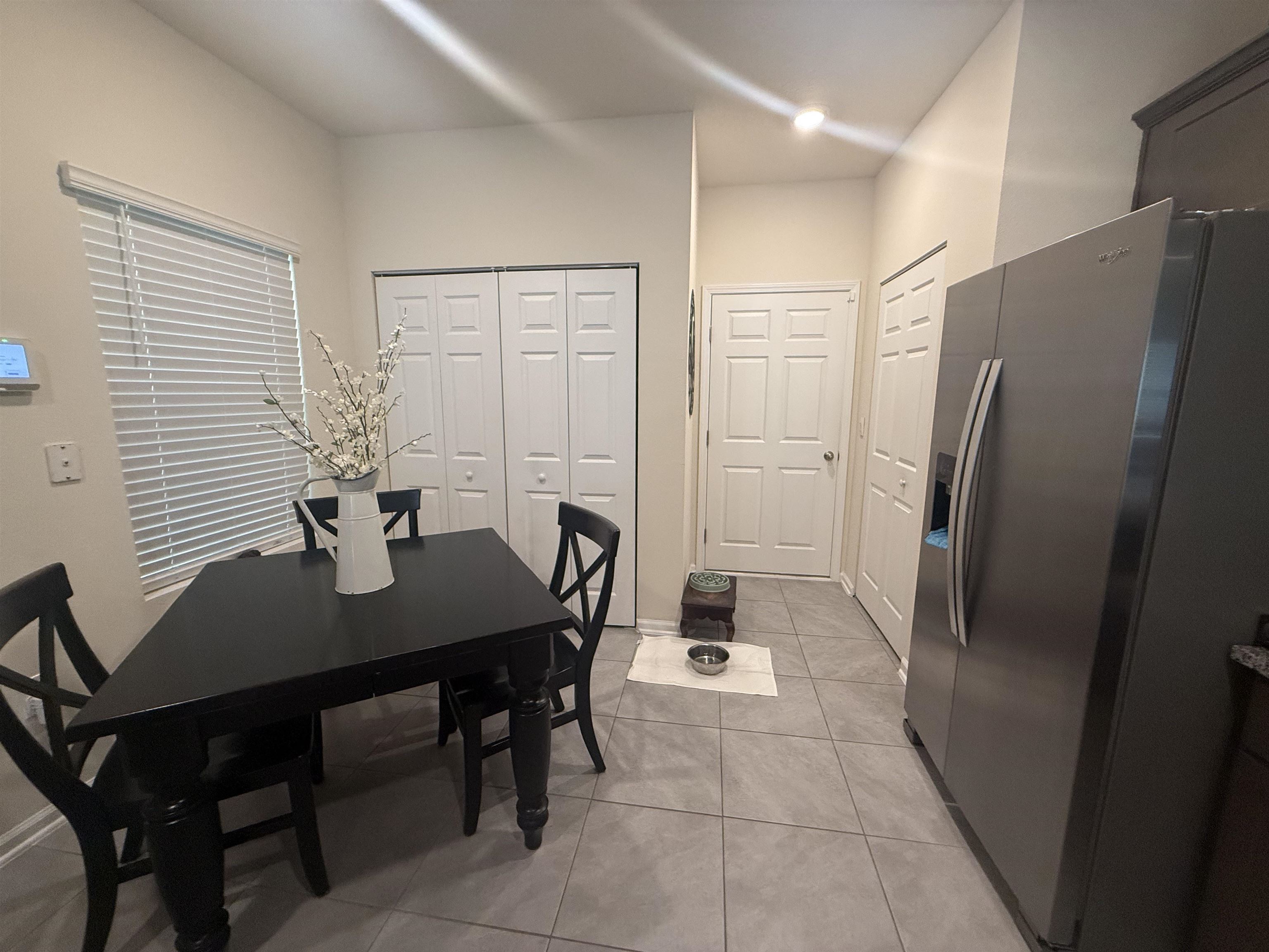 64 Coastline Way St. Augustine, FL 32092 - Photo 16 of 43 a kitchen with a table chairs and refrigerator