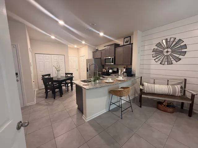 a living room with furniture and a lamp