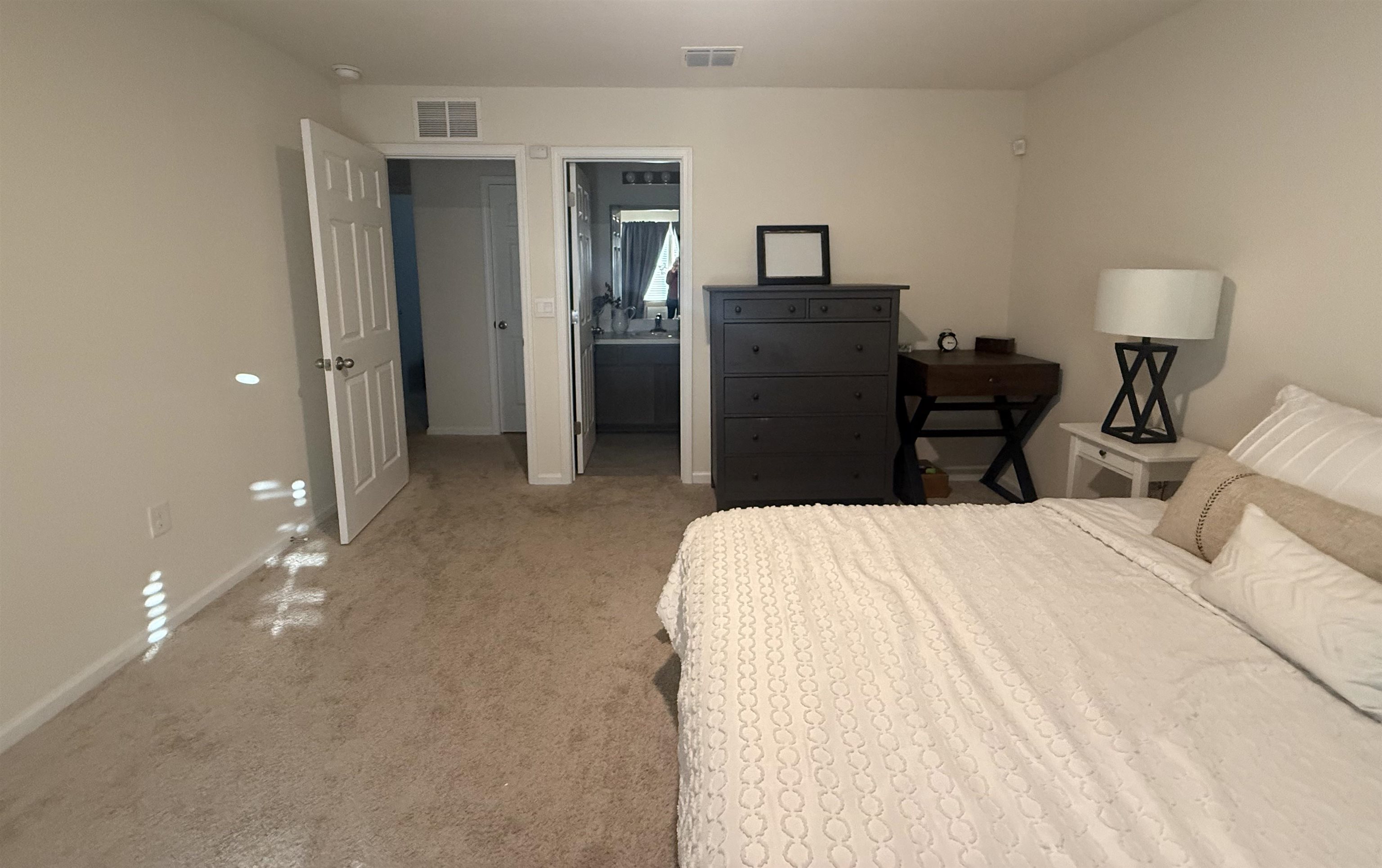 64 Coastline Way St. Augustine, FL 32092 - Photo 30 of 43 a bedroom with a bed and closet with lamp