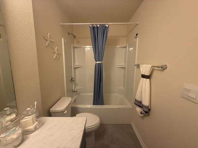 a bathroom with a sink toilet and a mirror