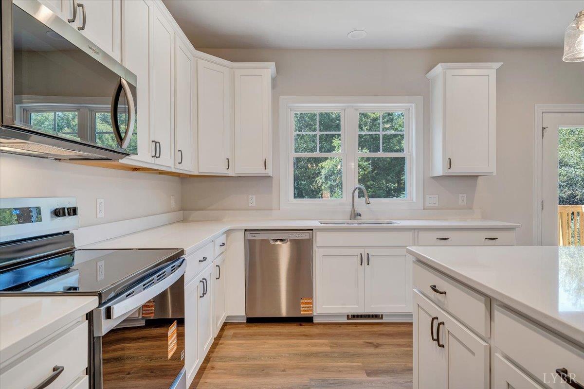 1053 Snowfield Circle Lynchburg, VA 24503 - Photo 11 of 29 a kitchen with stainless steel appliances granite countertop a sink stove and cabinets