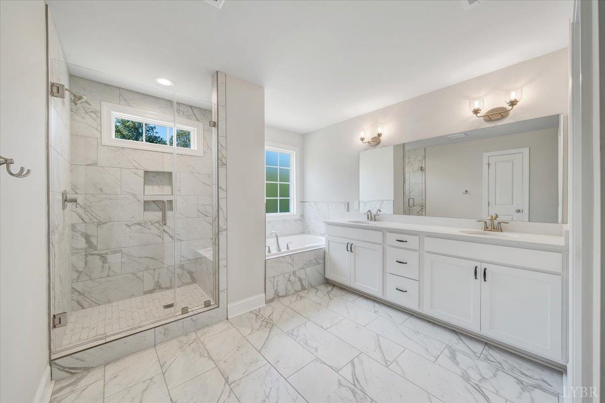 1053 Snowfield Circle Lynchburg, VA 24503 - Photo 16 of 29 a spacious bathroom with a shower sink and mirror
