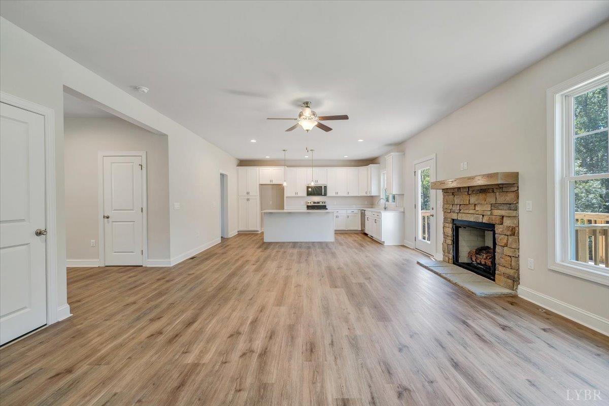 1053 Snowfield Circle Lynchburg, VA 24503 - Photo 7 of 29 wooden floor in an empty room with a fireplace