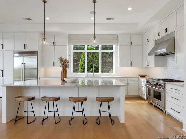 a large bed sitting in a bedroom next to a window