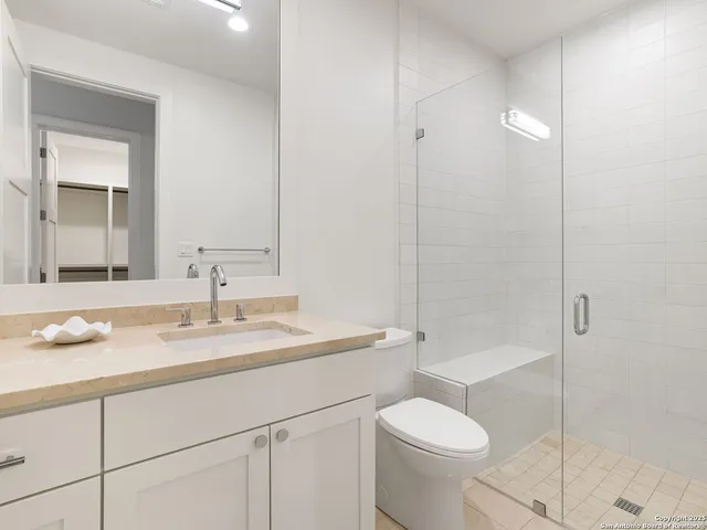 a living room with furniture a fireplace and a potted plant