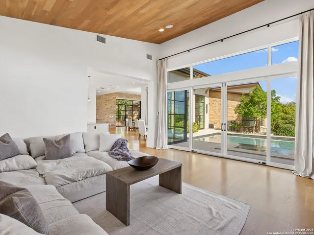 a living room with furniture and view of kitchen