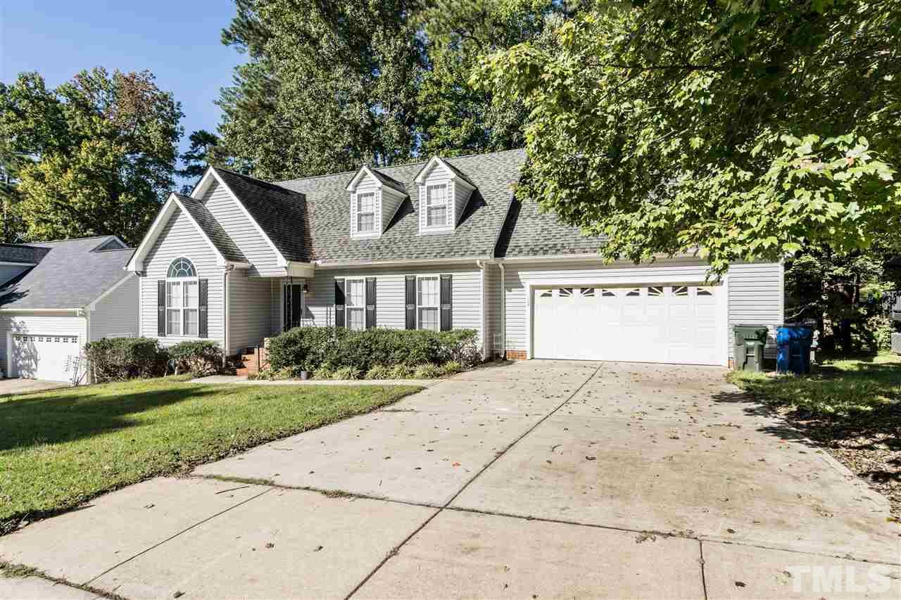 104 Fieldspring Lane Raleigh, NC 27606 - Photo 2 of 3 a front view of a house with a yard and garage