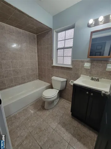 a bathroom with a sink a toilet and bathtub